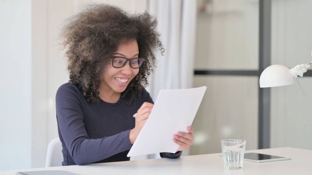 Successful African Woman Excited while Reading Documents - Photo, image