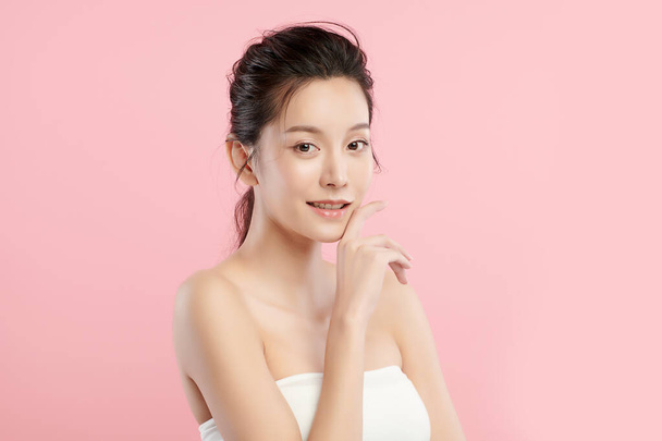 Beautiful young asian woman with clean fresh skin on pink background, Face care, Facial treatment, Cosmetology, beauty and spa, Asian women portrait. - Photo, Image