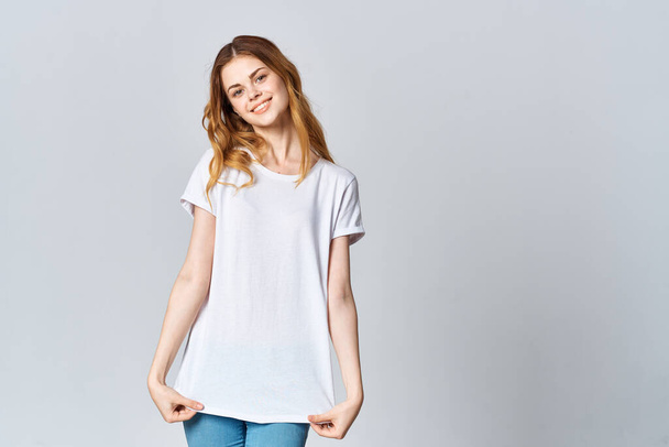 woman in white t-shirt and jeans posing. High quality photo - Photo, Image