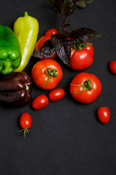 Multicolored farm vegetables on a black background - 写真・画像
