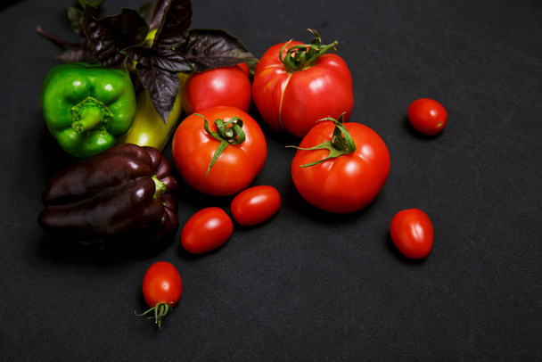 Multicolored farm vegetables on a black background - Photo, Image