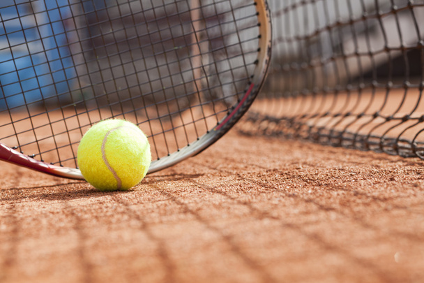 Close up of tennis racquet and balls on the clay tennis court - Фото, изображение