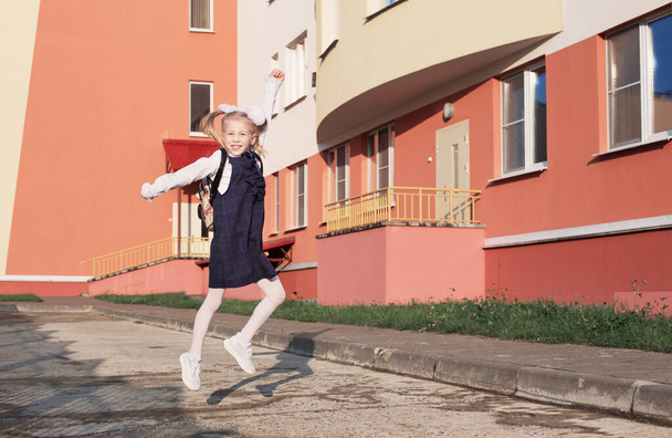 happy blonde  schoolgirl  go to school in sunny day - Foto, afbeelding
