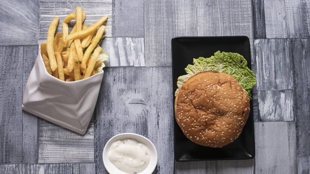 hamburger and sauce and fried potatoes - Photo, Image