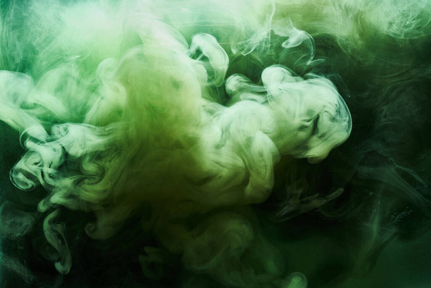 Abstract green color background. Swirling vibrant hookah smoke, underwater emerald ocean, dynamic paint in water - Fotó, kép