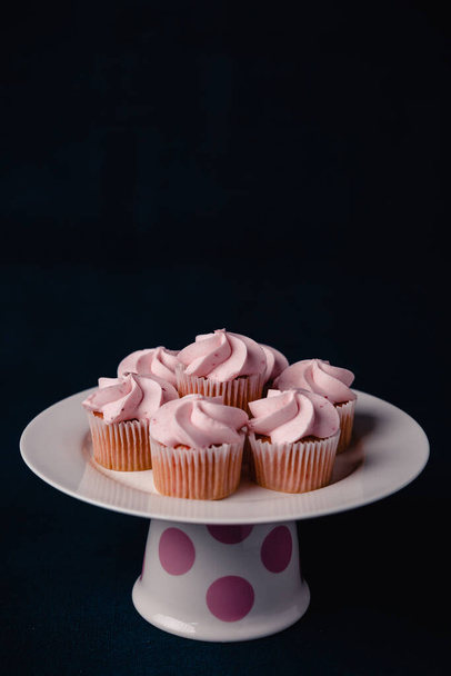 Pink mini strawberry cupcakes on a dark background - Zdjęcie, obraz
