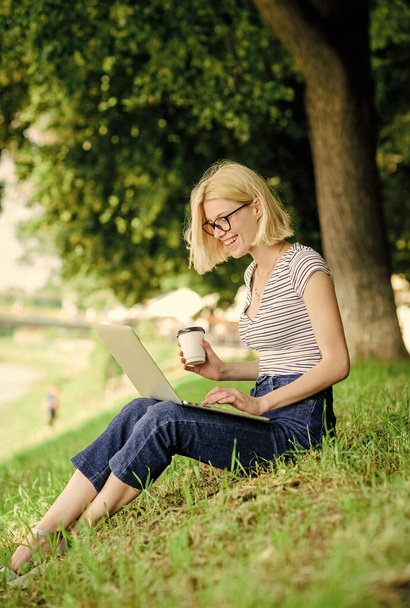 Girl laptop outdoors. Why employees need to work outdoors. Being outdoors exposes workers to fresher air and environmental variations making happy and healthy on physical and emotional level - Fotó, kép