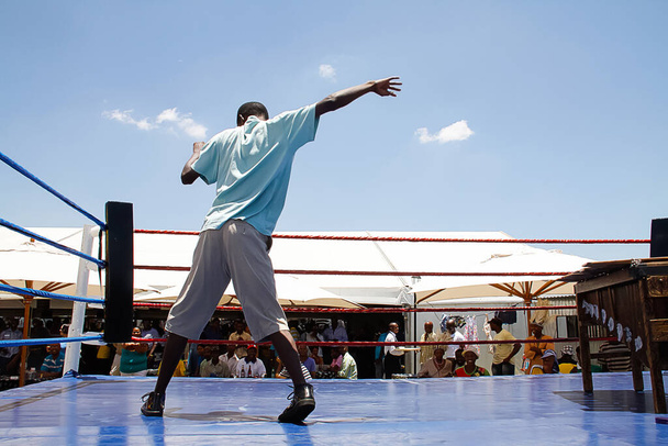 JOHANNESBURG, SOUTH AFRICA - Apr 24, 2019: African male break dancing on the blue stage in daytime - 写真・画像