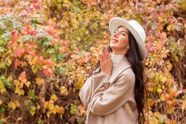 A beautiful woman enjoying the fall weather - Photo, Image