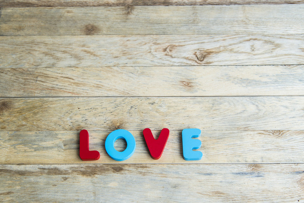 Colorful wooden word Love on wooden floor4 - Photo, Image