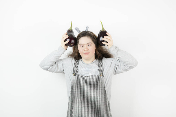 Photo of good-looking girl holding fresh healthy eggplants . High quality photo - Photo, image