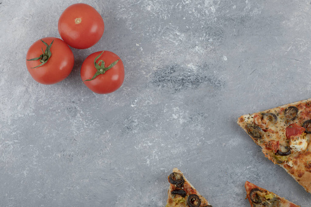 Slices of pizza with fresh red tomatoes on a white background . High quality photo - Foto, immagini