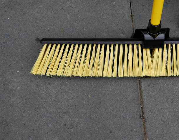 Yard broom with yellow bristles and handle with copy space - Φωτογραφία, εικόνα