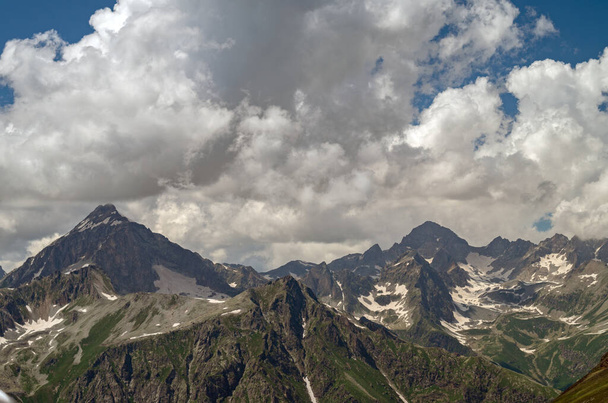 Beautiful mountain landscape with snowy peaks and clouds. highlands in summer.Caucasian mountains - Φωτογραφία, εικόνα