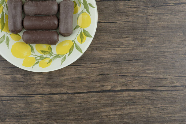 Cytrynowy wzór talerz smacznych batoników czekoladowych na drewnianej powierzchni. Wysokiej jakości zdjęcie - Zdjęcie, obraz
