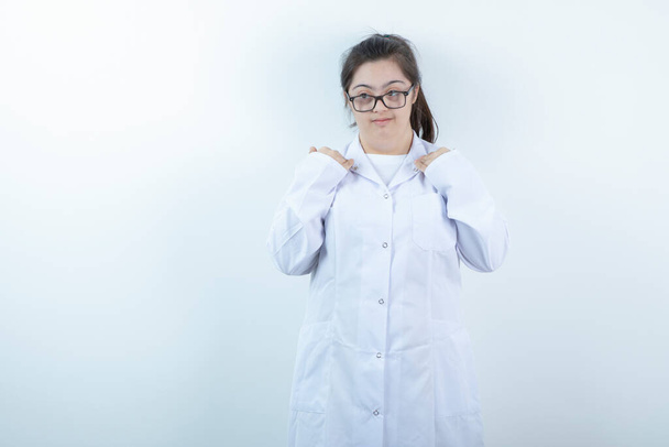 Young female girl in doctor's uniform standing and posing . High quality photo - Foto, afbeelding