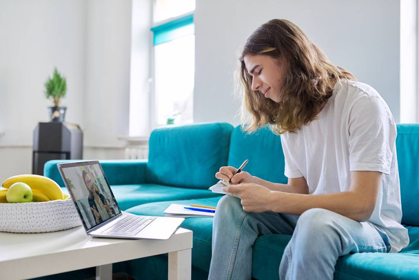 Individual online lesson, teenage boy studying at home with laptop - Photo, Image