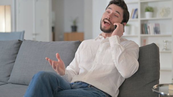Happy Man Talking on Phone at Home - Fotó, kép