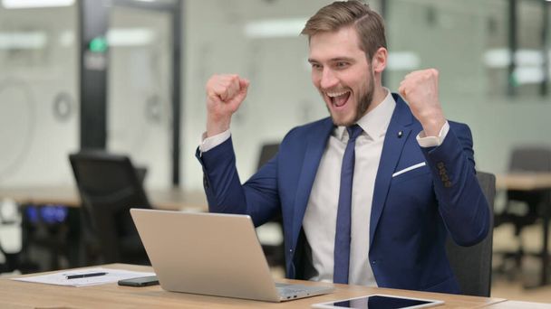 Businessman Celebrating on Laptop at Work  - Photo, Image