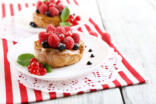 Sweet cakes with berries on table close-up - Foto, afbeelding