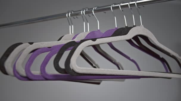 Clothes hangers, a man removes one hanger from a metal rack - Footage, Video