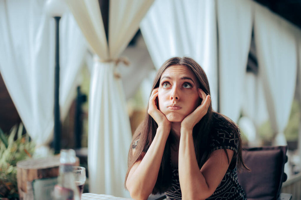Bored Girlfriend Waiting for her Date in a Restaurant  - 写真・画像