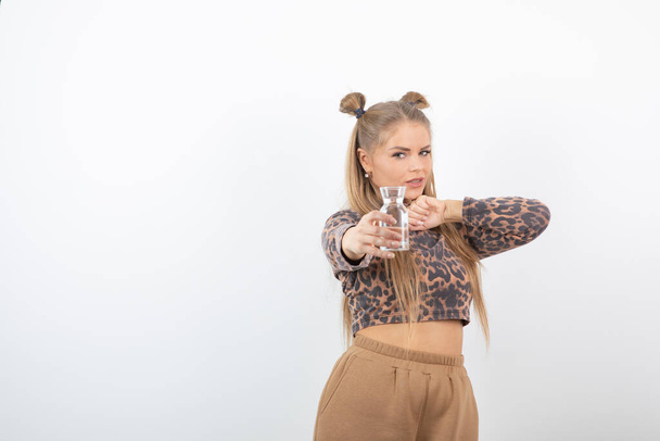 Image of beautiful woman in crop top holding glass of water. High quality photo - Photo, Image