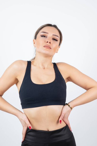 Image of fit young woman in black crop top standing and posing. High quality photo - Photo, Image