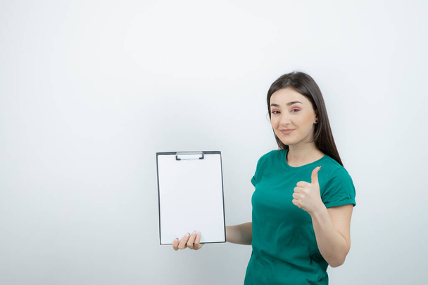 Portrait of girl company owner with clipboard showing thumb up. High quality photo - Fotó, kép