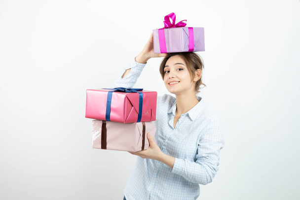 Portrait of a young cute girl holding present box with ribbon. High quality photo - Photo, image