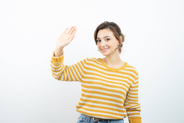 Picture of a young pretty woman model standing and waving hand . High quality photo - Photo, Image