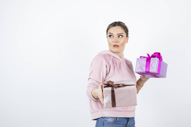 Portrait of young beautiful woman with gift boxes standing. High quality photo - Fotoğraf, Görsel