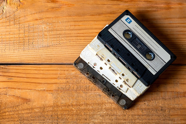 Old Audio Cassettes on a Wooden Planks Background closeup - Photo, image