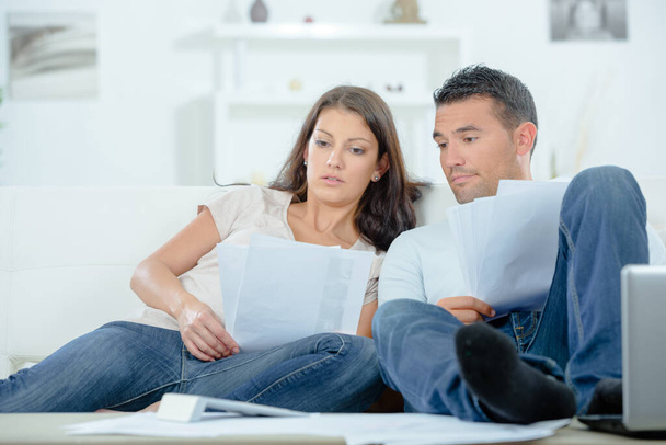 couple at home looking through paperwork - Photo, image
