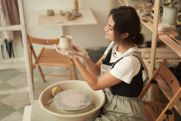 Artisan making earthenware in pottery studio - Photo, Image
