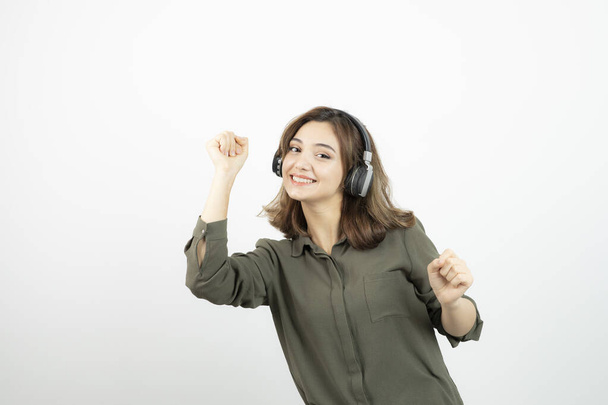 Image of young attractive woman in headphones listening to song. High quality photo - Fotoğraf, Görsel