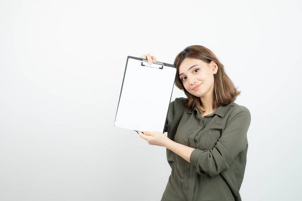Portrait of young adorable woman showing blank clipboard. High quality photo - Photo, Image