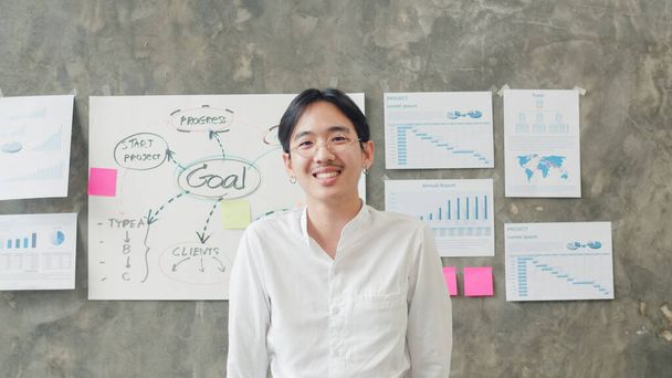 Portrait of successful handsome executive businessman smart casual wear looking at camera and smiling, happy in modern office workplace. Young Asia guy standing relax in contemporary coworking space. - Photo, Image
