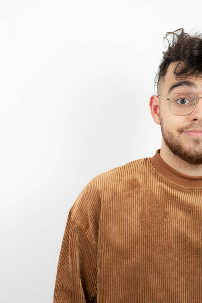 Portrait of young handsome guy in glasses looking at camera. High quality photo - Photo, Image
