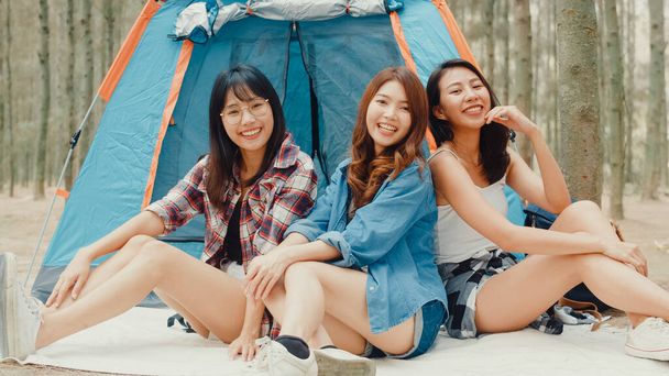 若いアジアのキャンプの友人のグループは、森林での瞬間をお楽しみください。キャンプ場で自撮りスマートフォンを使う女性旅行者。野外活動、冒険旅行、または休暇. - 写真・画像
