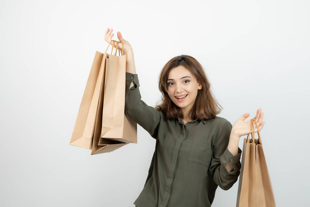 Young female model with craft bags standing and posing. High quality photo - Foto, afbeelding