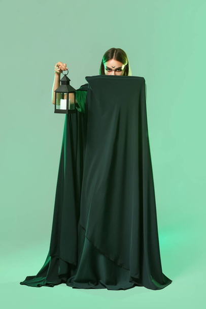 Beautiful woman dressed as witch for Halloween on color background - Photo, Image