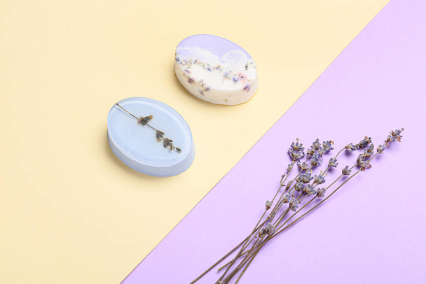 Soap bars and lavender flowers on color background - Photo, Image