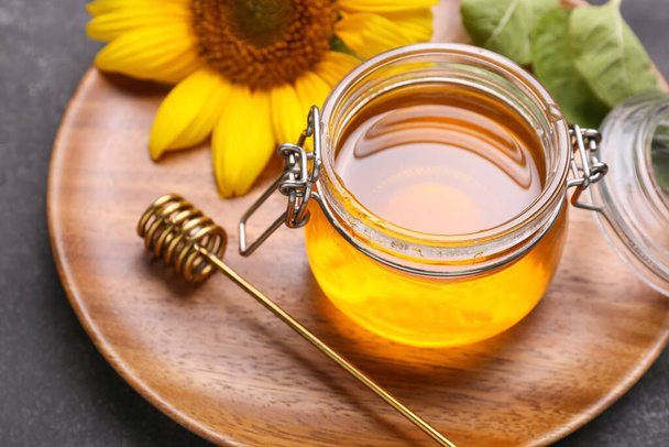 Jar of honey on dark background - Фото, зображення