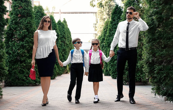 Cute little children going to school with their parents - Valokuva, kuva