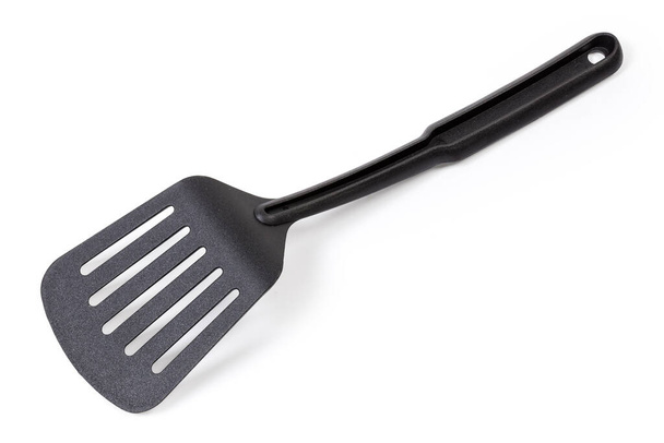 Inverted plastic kitchen spatula used for non stick pans on a white background - Photo, Image