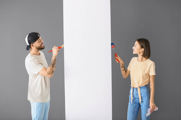 Young couple painting wall in room - Photo, image