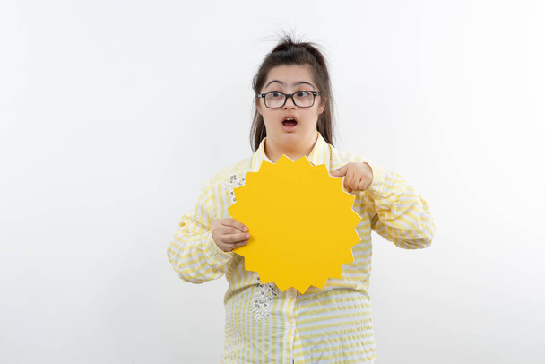 chica con síndrome de Down posando con amarillo sol figura corte papel - Foto, Imagen