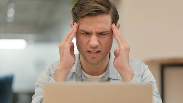 Close up of Young Man with Laptop having Headache  - Fotografie, Obrázek