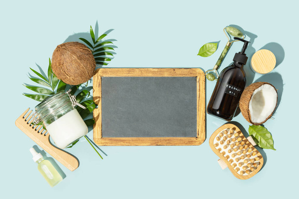 Spa coconut products flat lay with chalkboard, face, body and hair organic treatment concept - 写真・画像